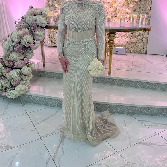 Stunning fully beaded gown featuring a mesh see through corset. Stunning fully beaded gown featuring a mesh see through corset.